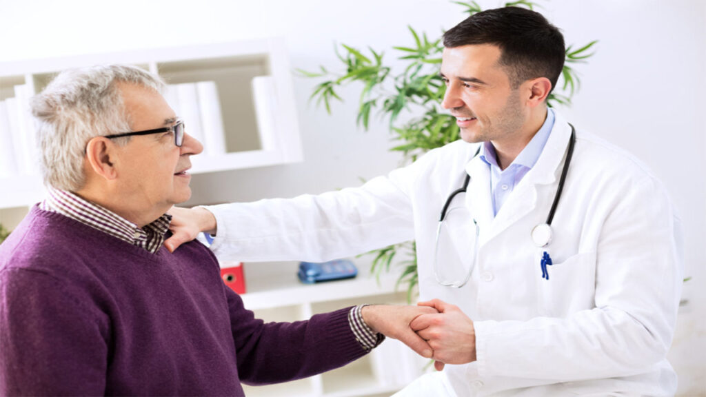 Naturopathic Remedies for IBS Relief 6 Remedies for IBS Relief: Doctor in white coat consulting elderly patient in purple sweater, shaking hands in a modern office with plants